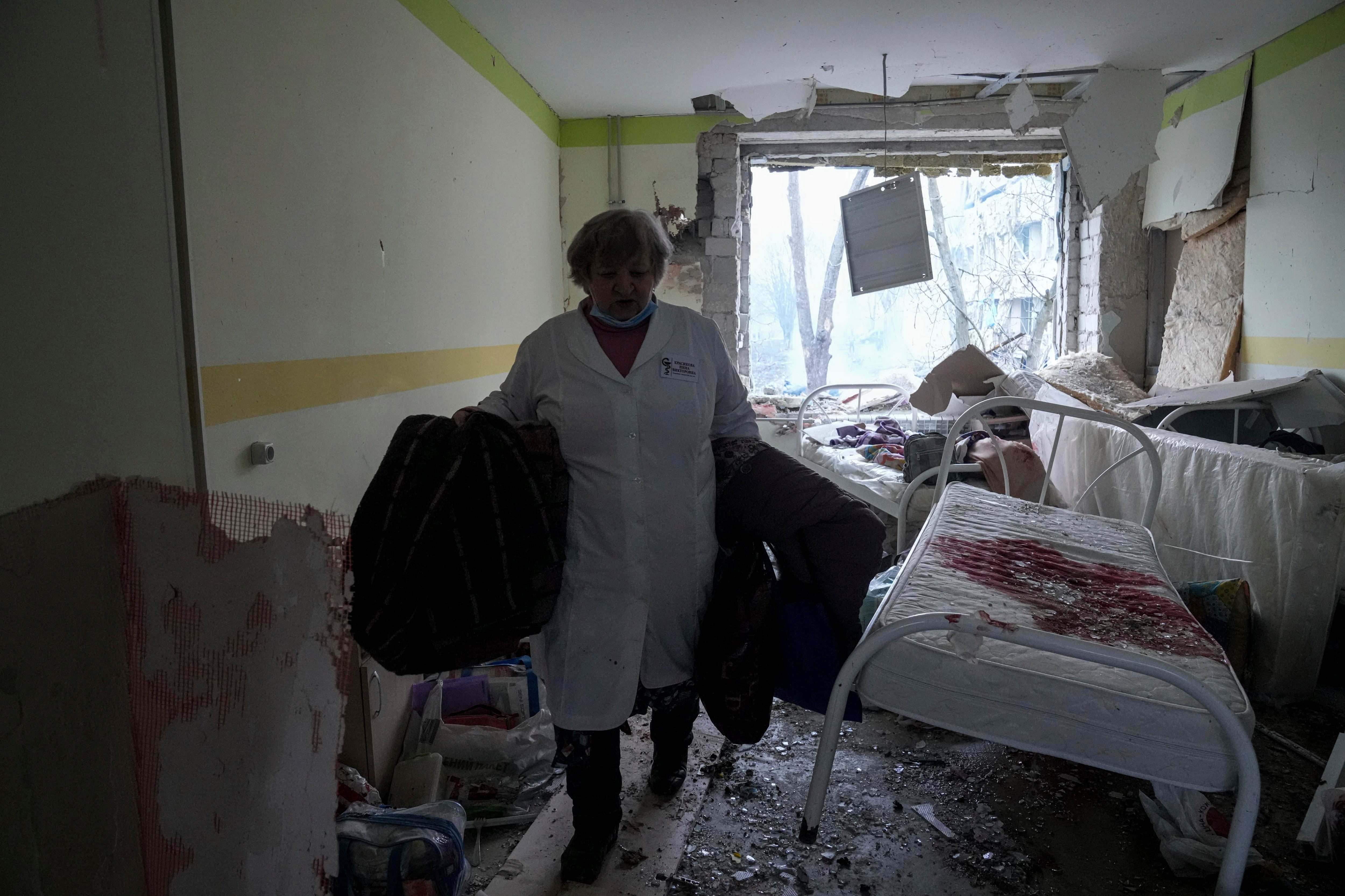 A medical worker walks inside of the damaged by shelling maternity hospital in Mariupol