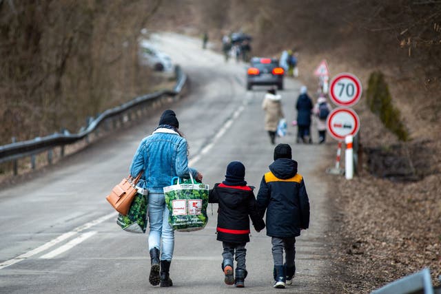 <p>A woman with two children after crossing the Slovak-Ukrainian border in Ubla, eastern Slovakia on 25 February, 2022 </p>