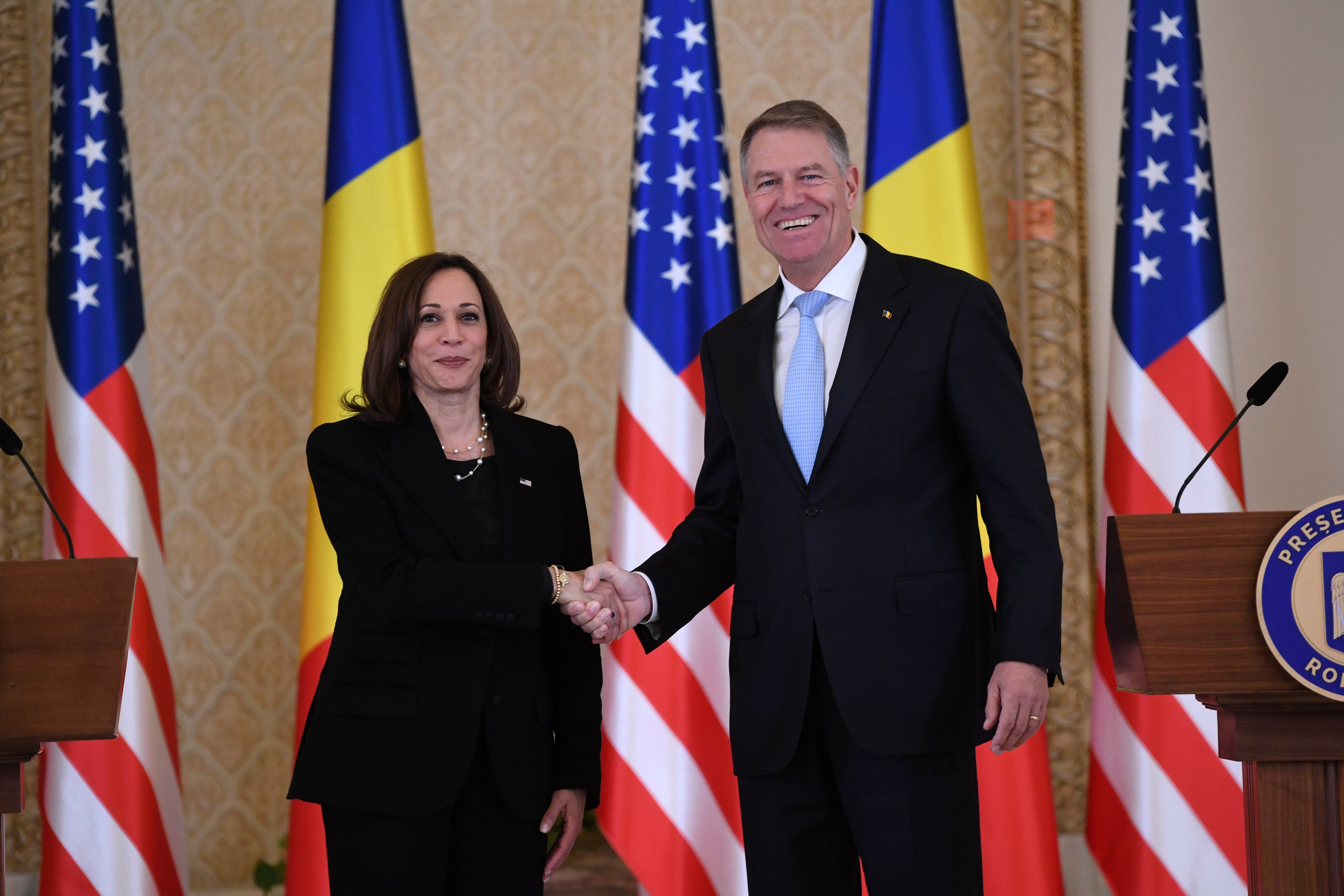 Vice President Kamala Harris shakes hands with Romanian President Klaus Iohannis following their joint press conference at Cotroceni Palace in Otopeni, Romania