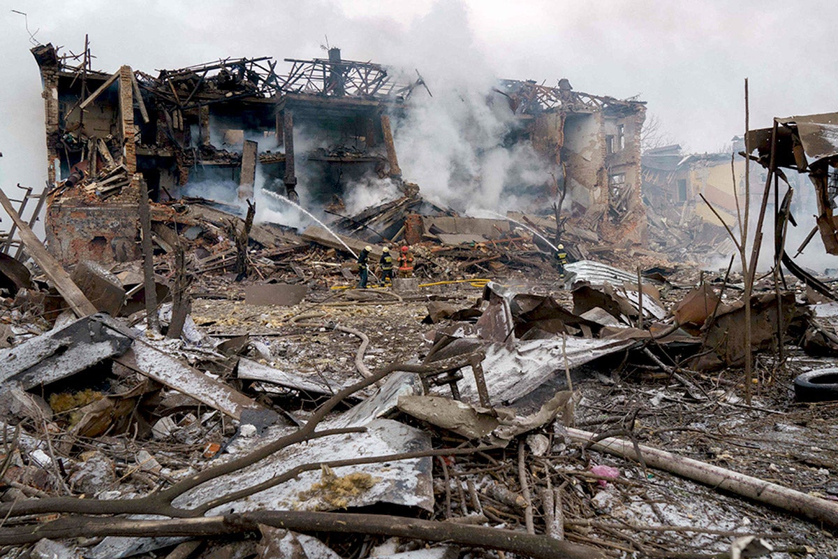 Firefighters spray water on a destroyed shoe factory following an airstrike in Dnipro on Friday