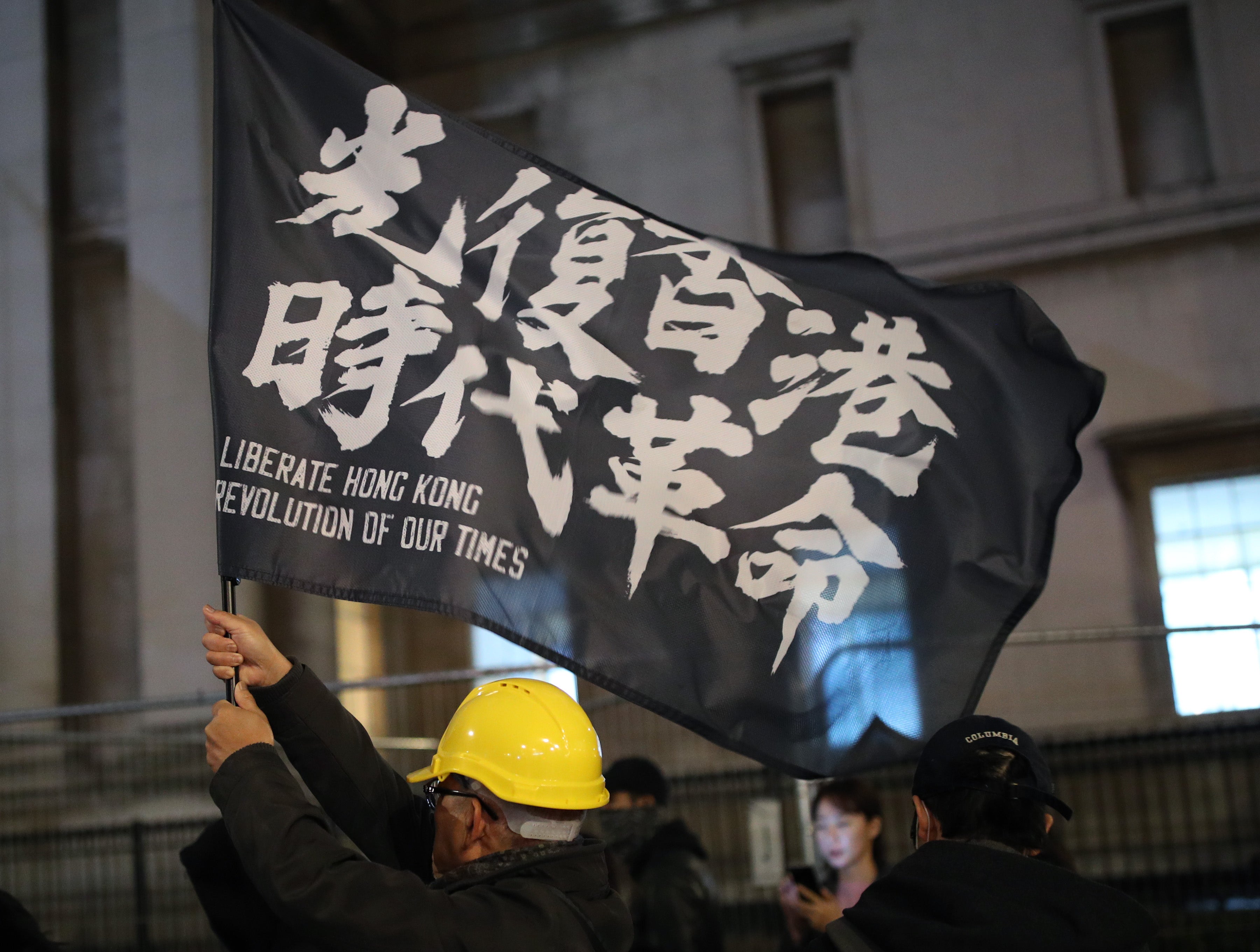 Hong Kong pro-democracy protesters taking part in a Hong Kong solidarity rally in Trafalgar Square, London (Yui Mok/PA)