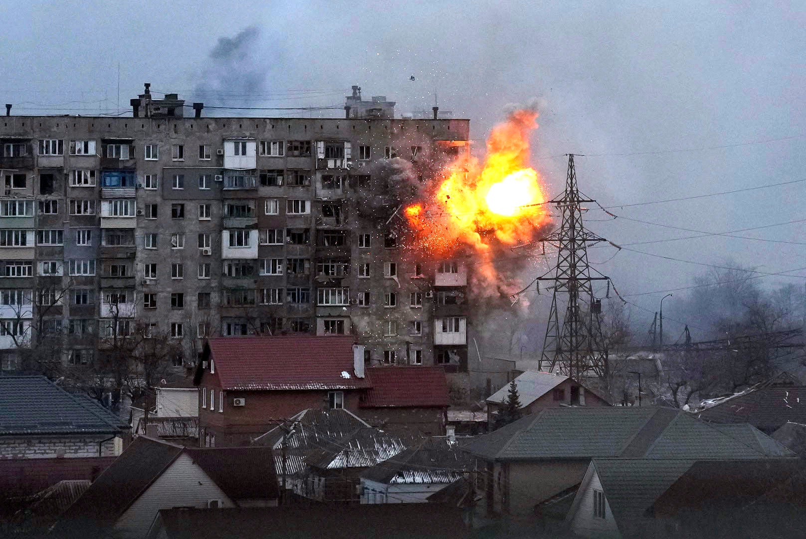 An explosion is seen in an apartment building after Russian’s army tank fires in Mariupol