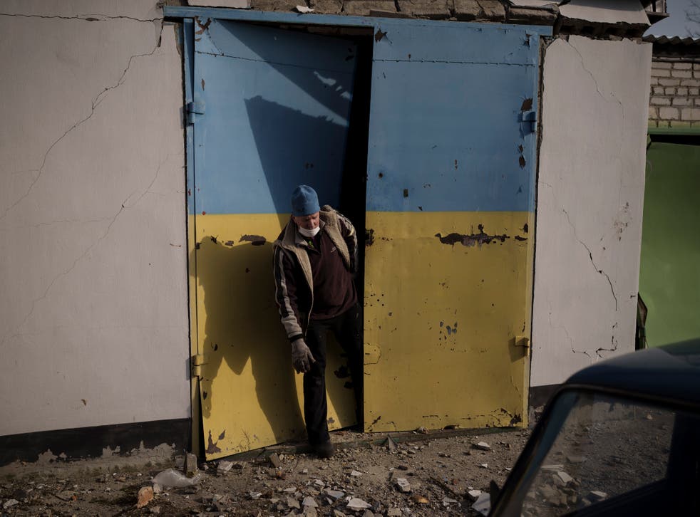 A man tries to open a door damaged after a Russian bombing in Baryshivka, east of Kyiv, Ukraine (Felipe Dana/AP)