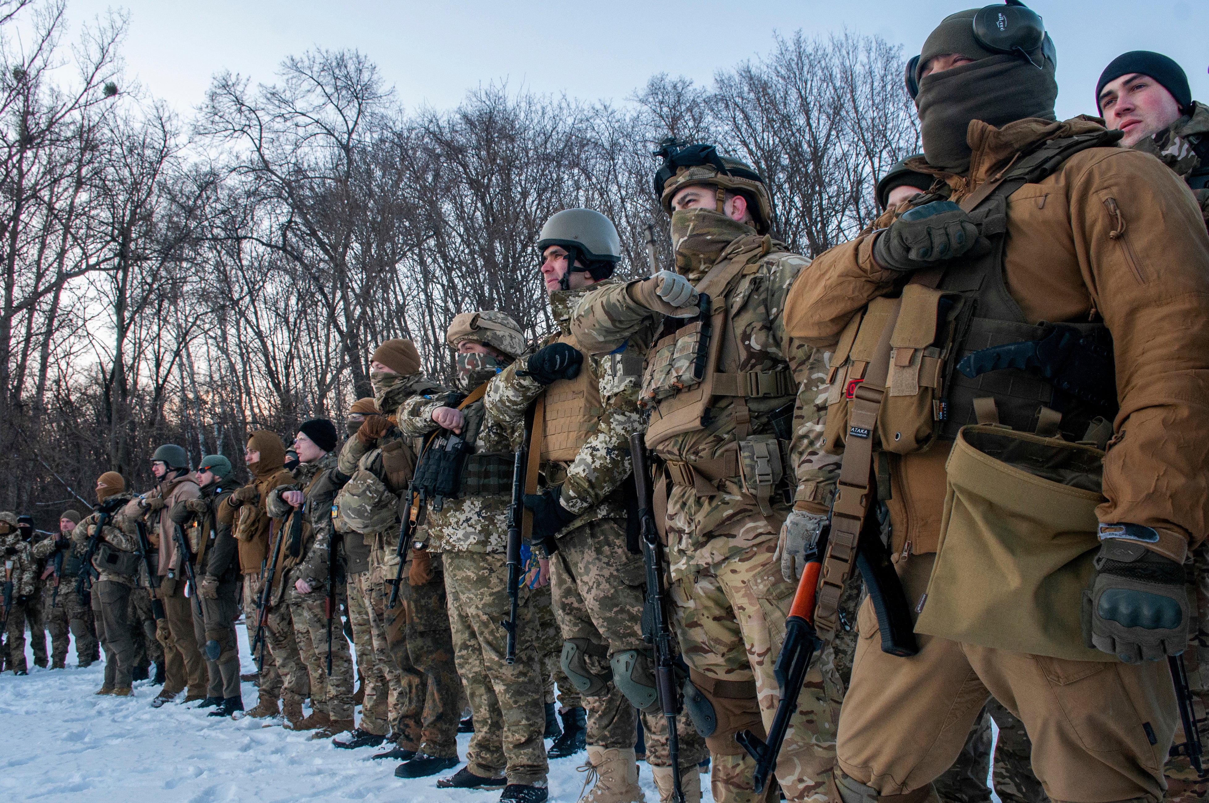 Ukrainian servicemen gesture during a training session outside Kharkiv, Ukraine (Andrew Marienko/AP)