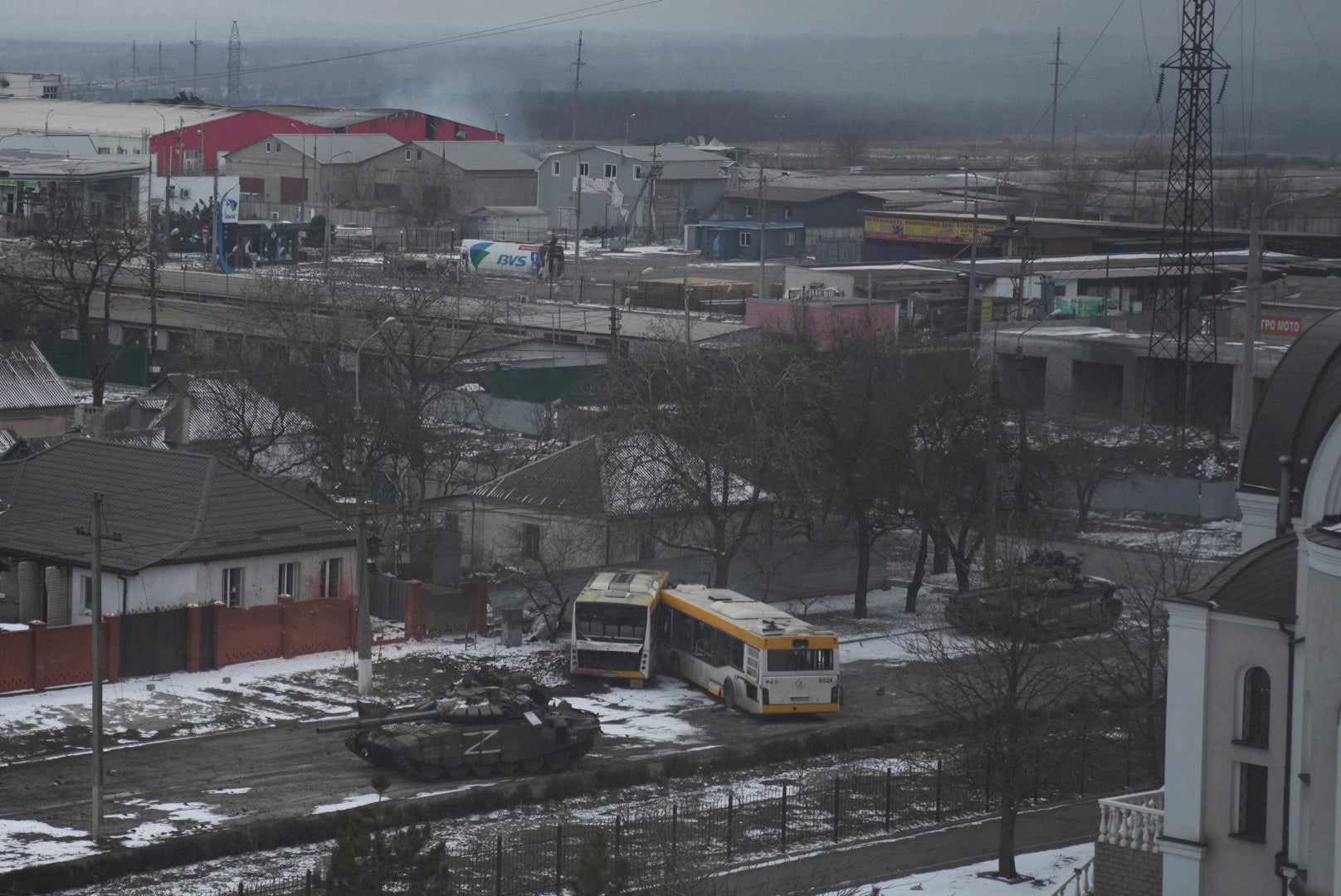 Russian’s army tanks move through a street on the outskirts of Mariupol, Ukraine (Evgeniy Maloletka/AP)