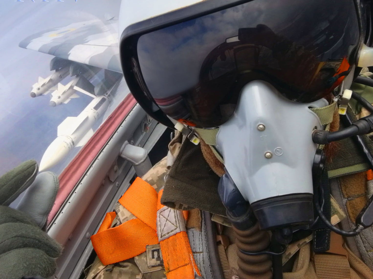 The fighter pilot’s face is completely obscured by his gear