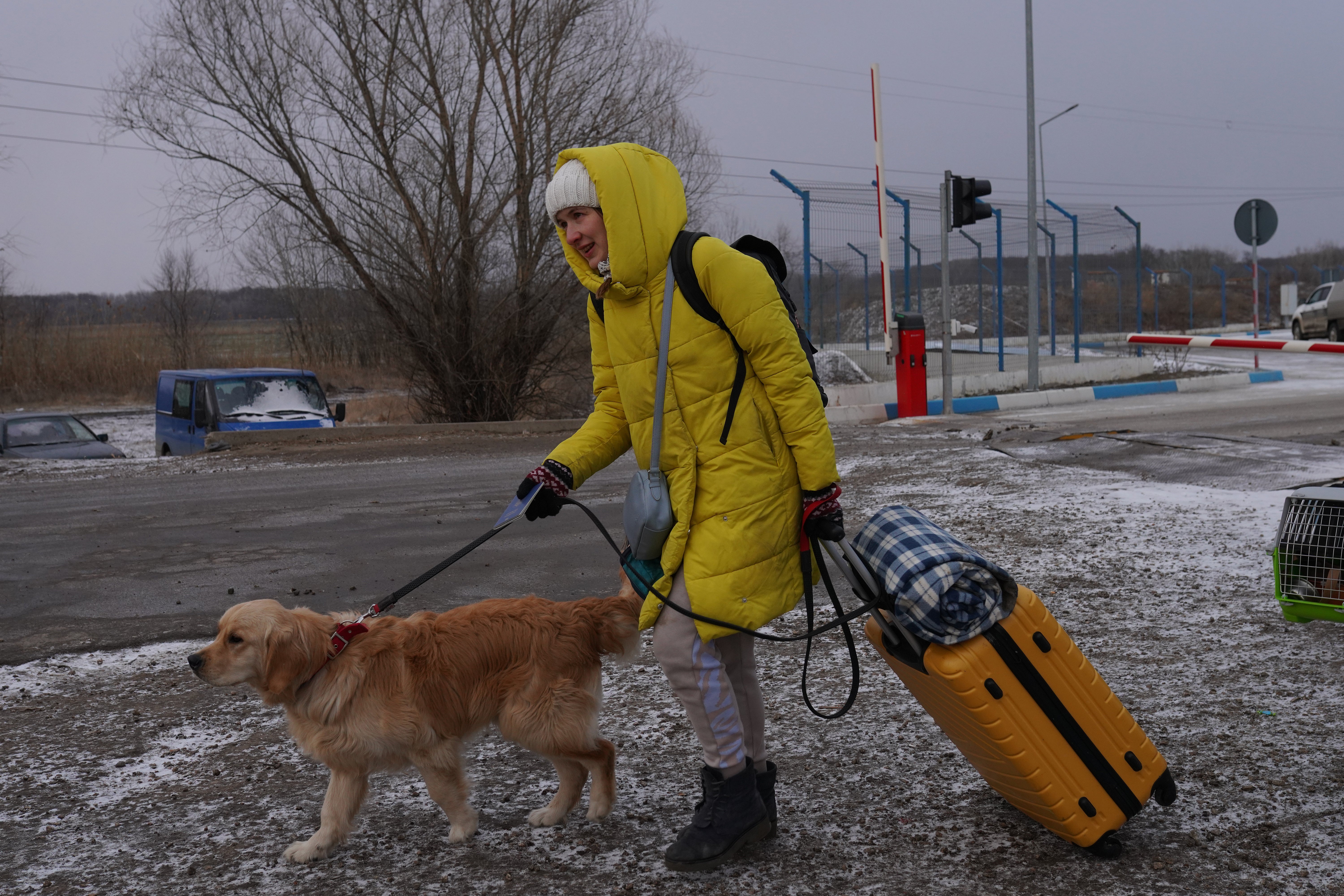 A woman fleeing the conflict in Ukraine crosses the border into Moldova