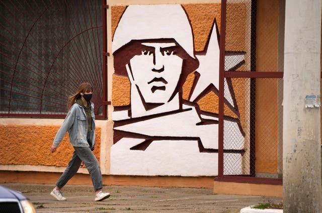 <p>A woman walks past the Operational Group of Russian Forces headquarters in Tiraspol, the capital of the breakaway region of Transnistria</p>