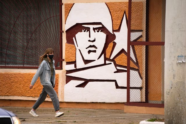 <p>A woman walks past the Operational Group of Russian Forces headquarters in Tiraspol, the capital of the breakaway region of Transnistria</p>