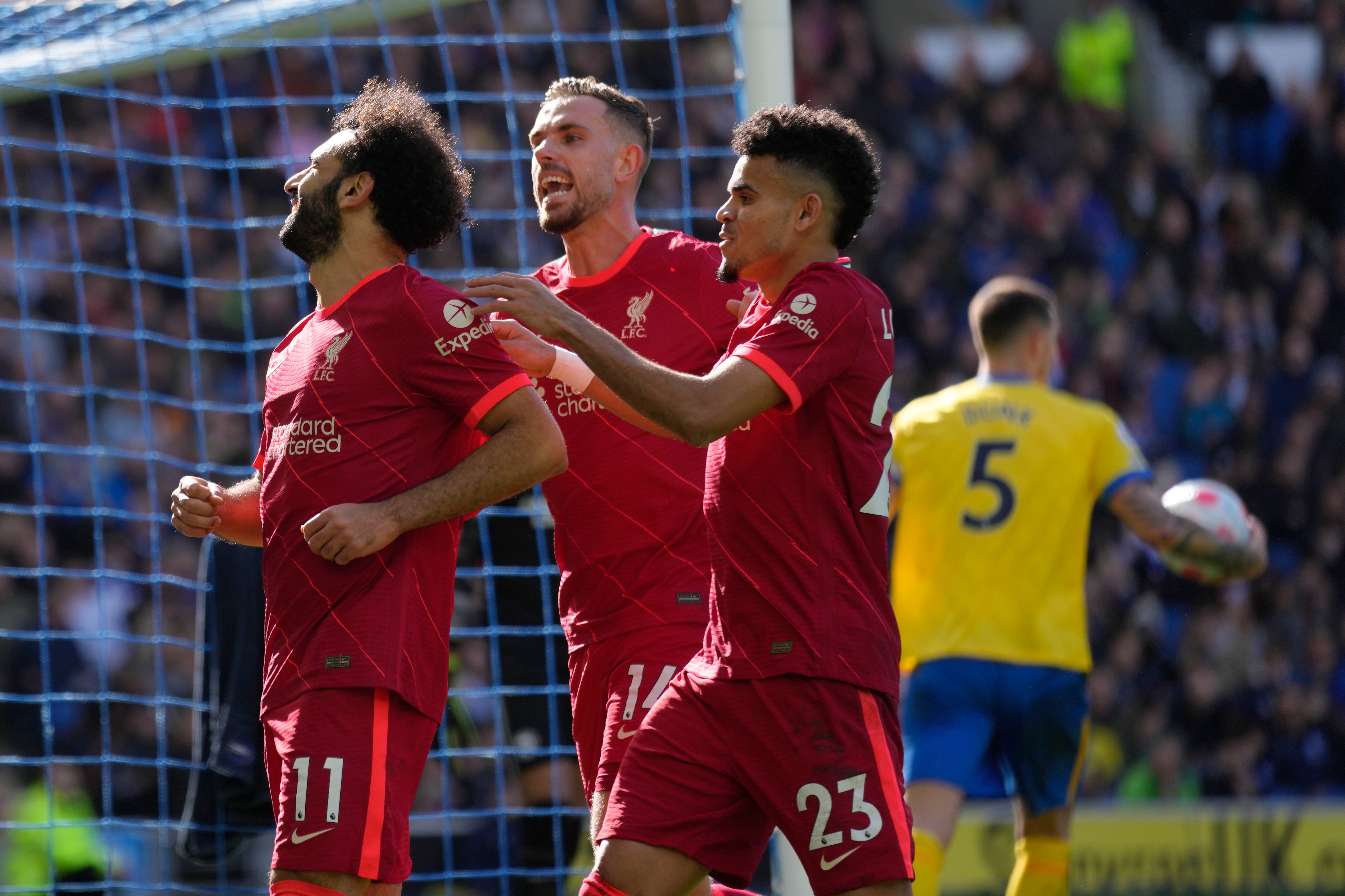 Liverpool's Mohamed Salah, left, celebrates with his teammates Jordan Henderson and Luis Diaz