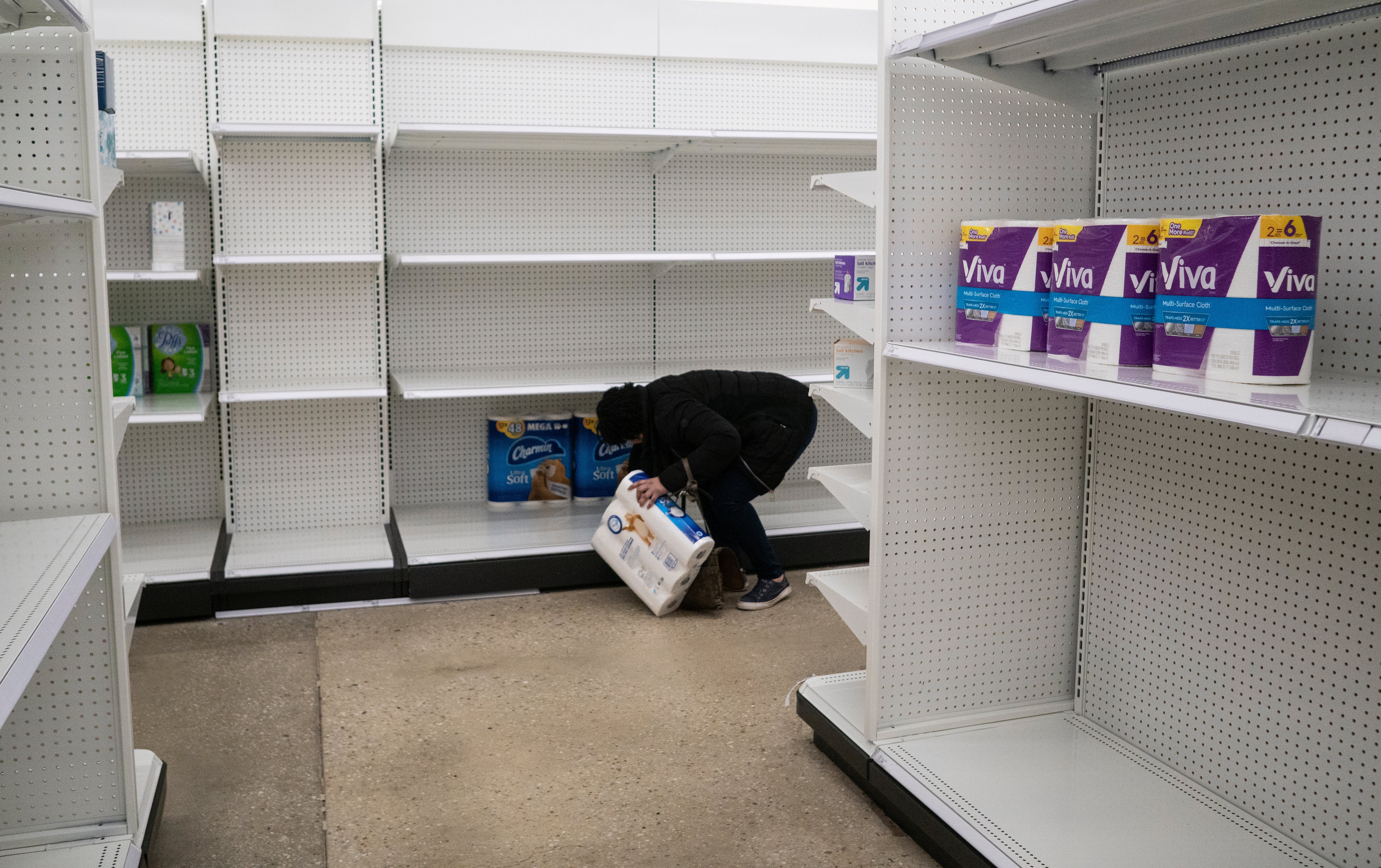 A woman reaches for one of the last packages of toilet paper at Target in the Tenleytown area of Washington in 2020 during the pandemic