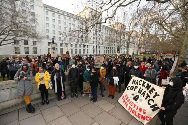 People attend the protest organised by the feminist action group Sisters Uncut outside the headquarters of the Metropolitan Police, New Scotland Yard, in London (James Manning/PA)