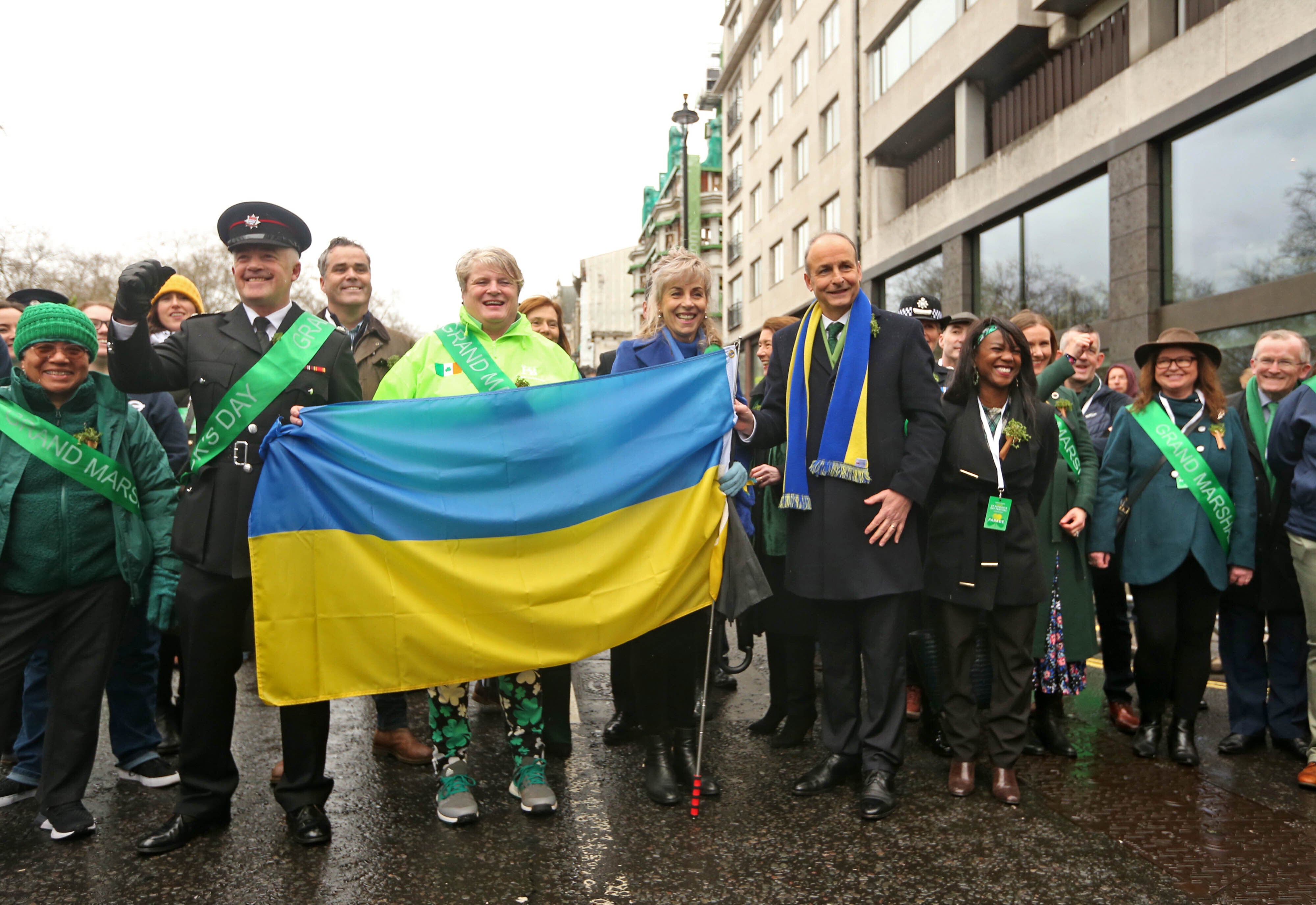 Taoiseach Micheal Martin (centre right) with the grand marshals including Natalia Lesyuk during the St Patrick’s Day parade in London (James Manning/PA)