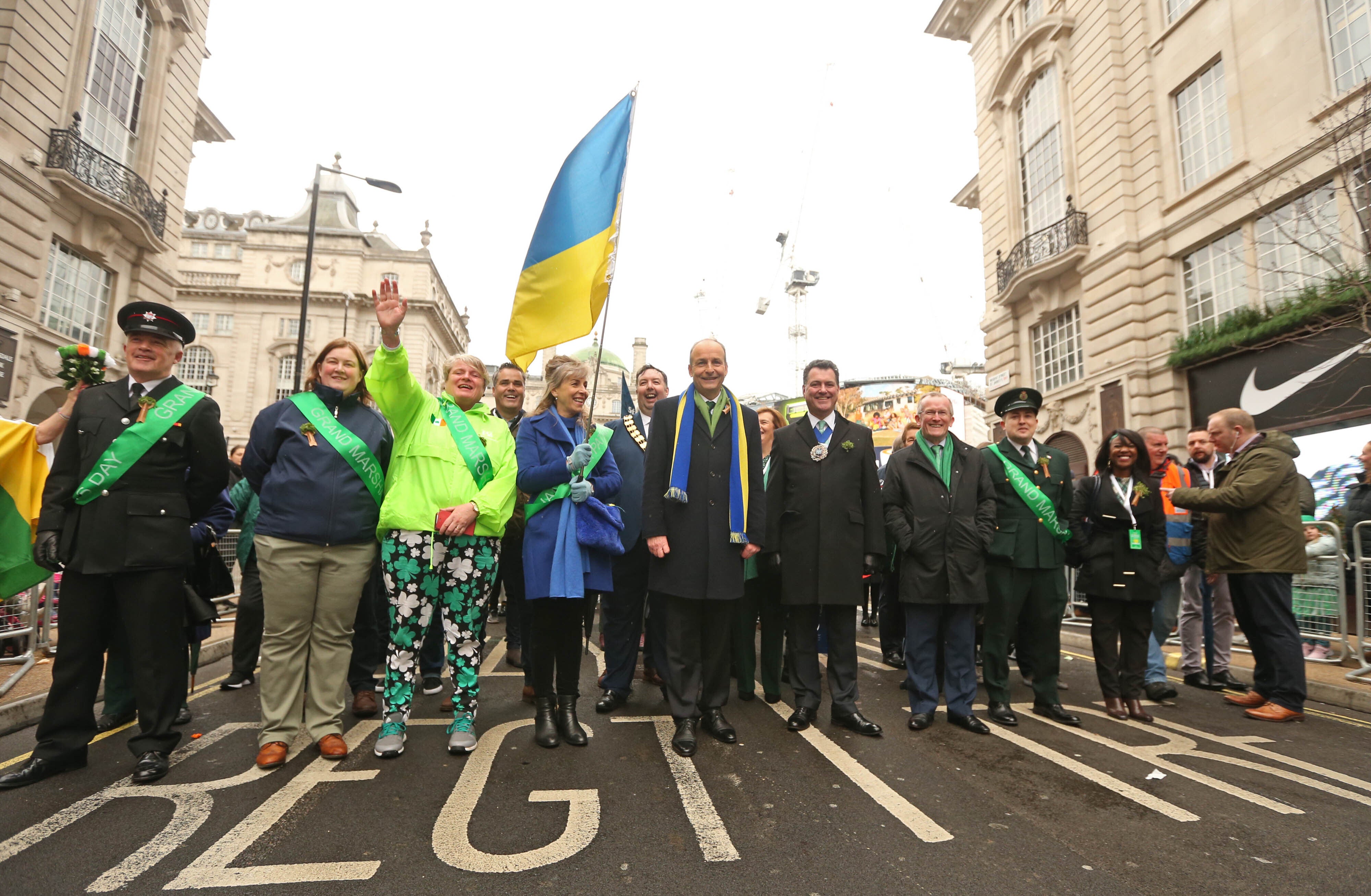 Taoiseach Micheal Martin (centre) with Natalia Lesyuk from the Ukraine (centre left with flag) during the St Patrick’s Day parade in London. Picture date: Sunday March 13, 2022.