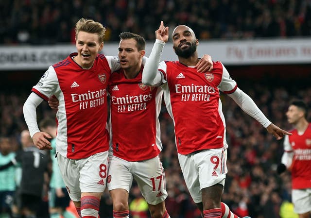 <p>Alexandre Lacazette celebrates his penalty alongside the outstanding Martin Odegaard </p>