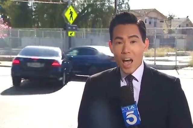 <p>KTLA reporter Gene Kang speaks as cars collide behind him</p>