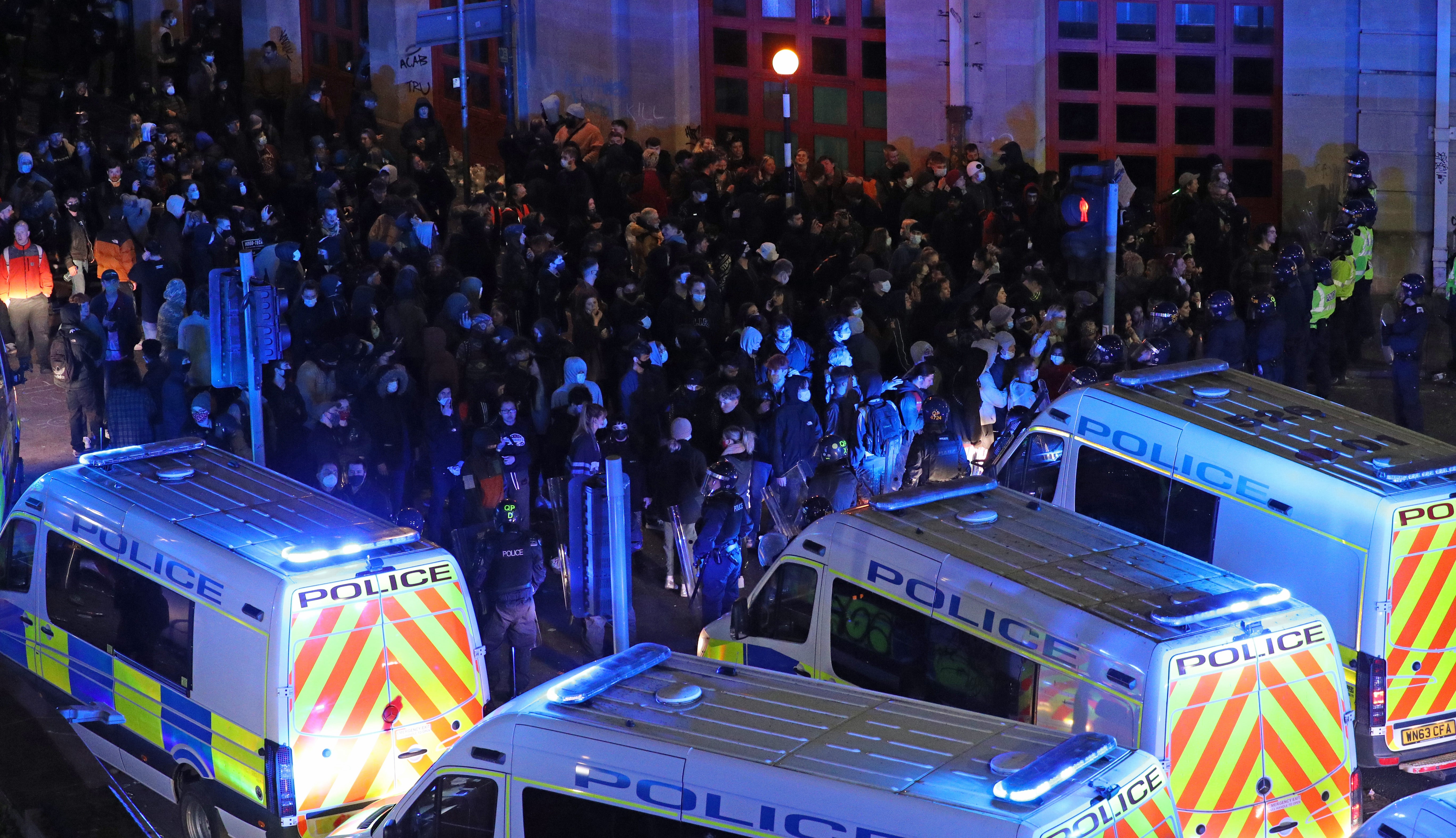 Riot police, with police horses and police vehicles, move down Rupert Street in Bristol towards protesters (Andrew Matthews/PA)