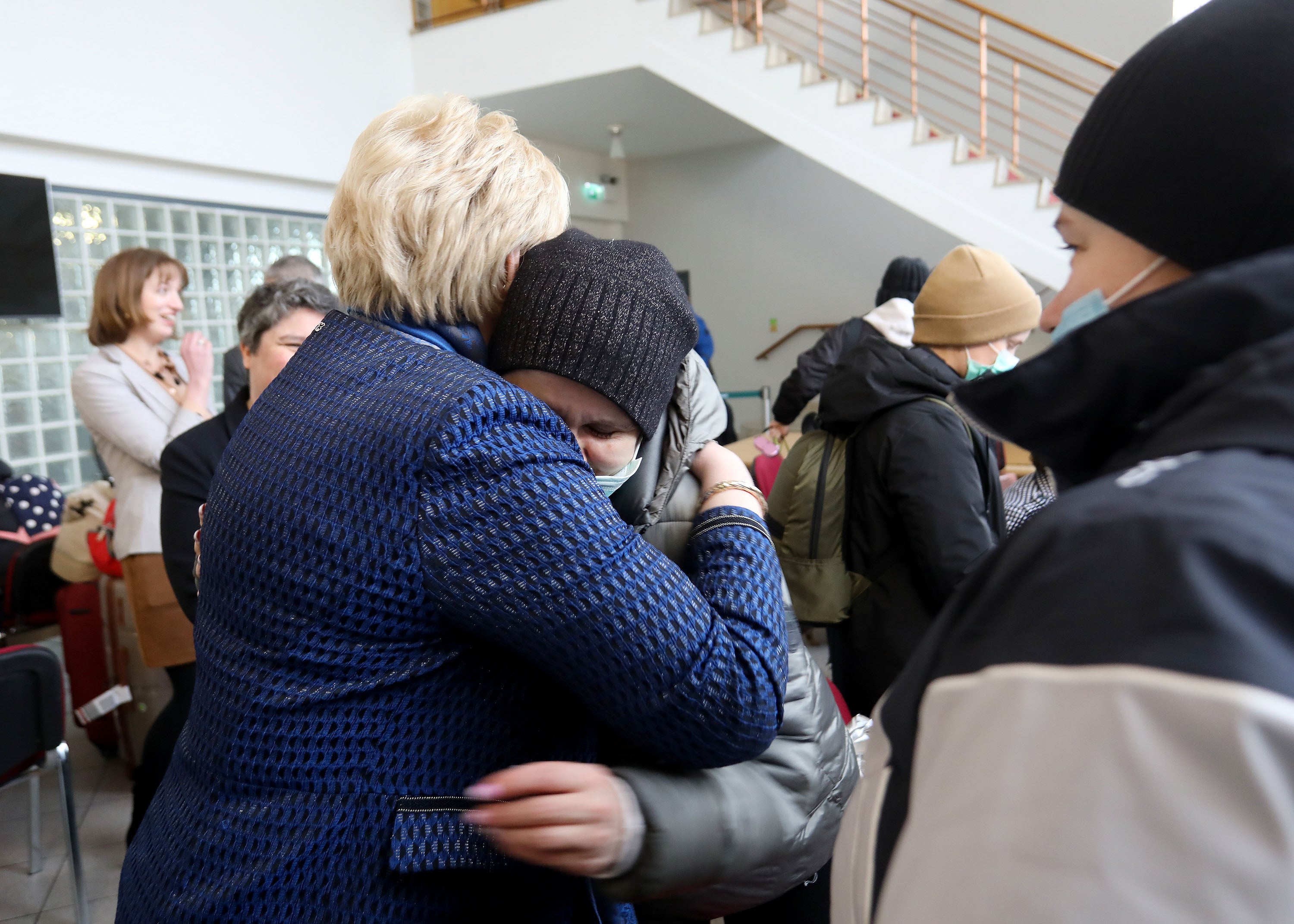 Heather Humphreys, Ireland’s social protection minister, hugs Valentina Roman and Liudmyla Bodak at a reception facility at Dublin airport, on 9 March 2022