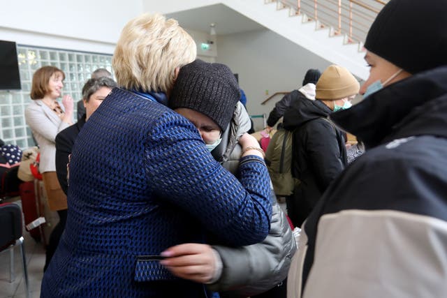 <p>Heather Humphreys, Ireland’s social protection minister, hugs Valentina Roman and Liudmyla Bodak at a reception facility at Dublin airport, on 9 March 2022 </p>