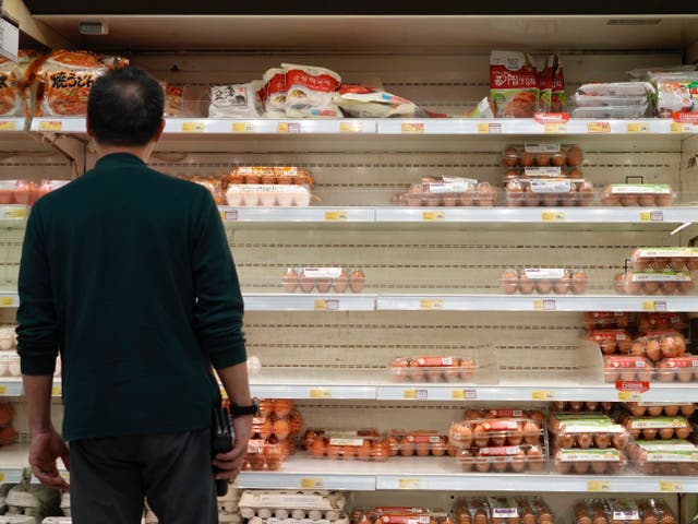 <p>A man stocks up on eggs in Hong Kong on 7 March</p>