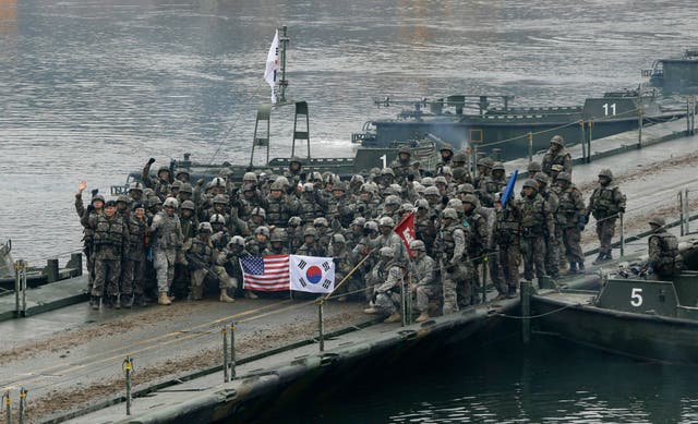 <p>File: United States and South Korean army soldiers pose on a floating bridge on the Hantan river </p>