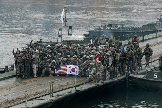 <p>File: United States and South Korean army soldiers pose on a floating bridge on the Hantan river </p>