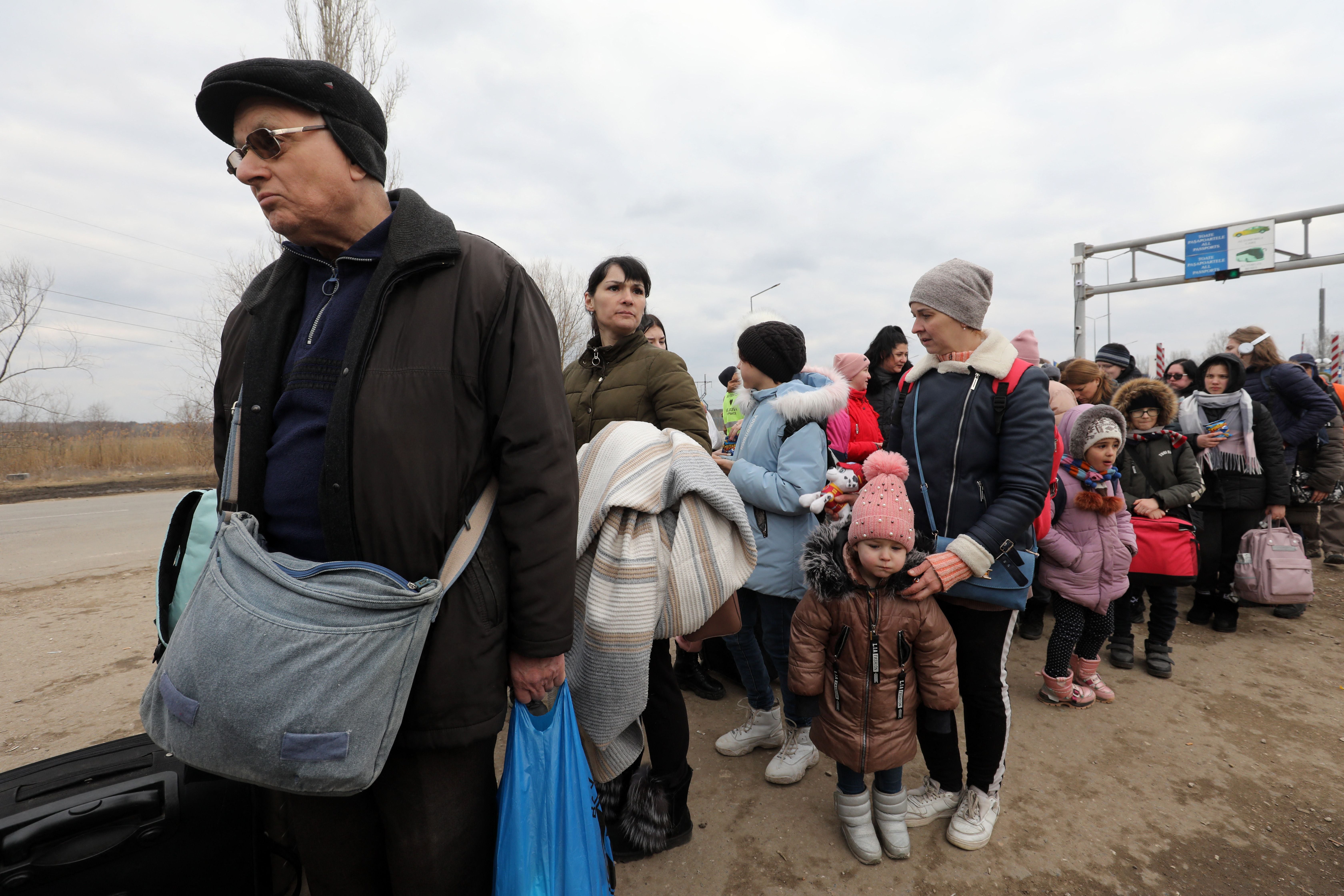 People fleeing Russia’s invasion cross the Moldova-Ukraine border checkpoint near the village of Palanka, Moldova, 14 March 2022