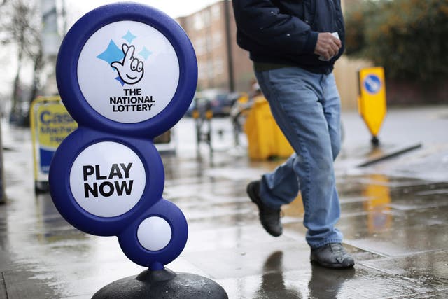 A National Lottery sign outside a newsagent in north London (PA)