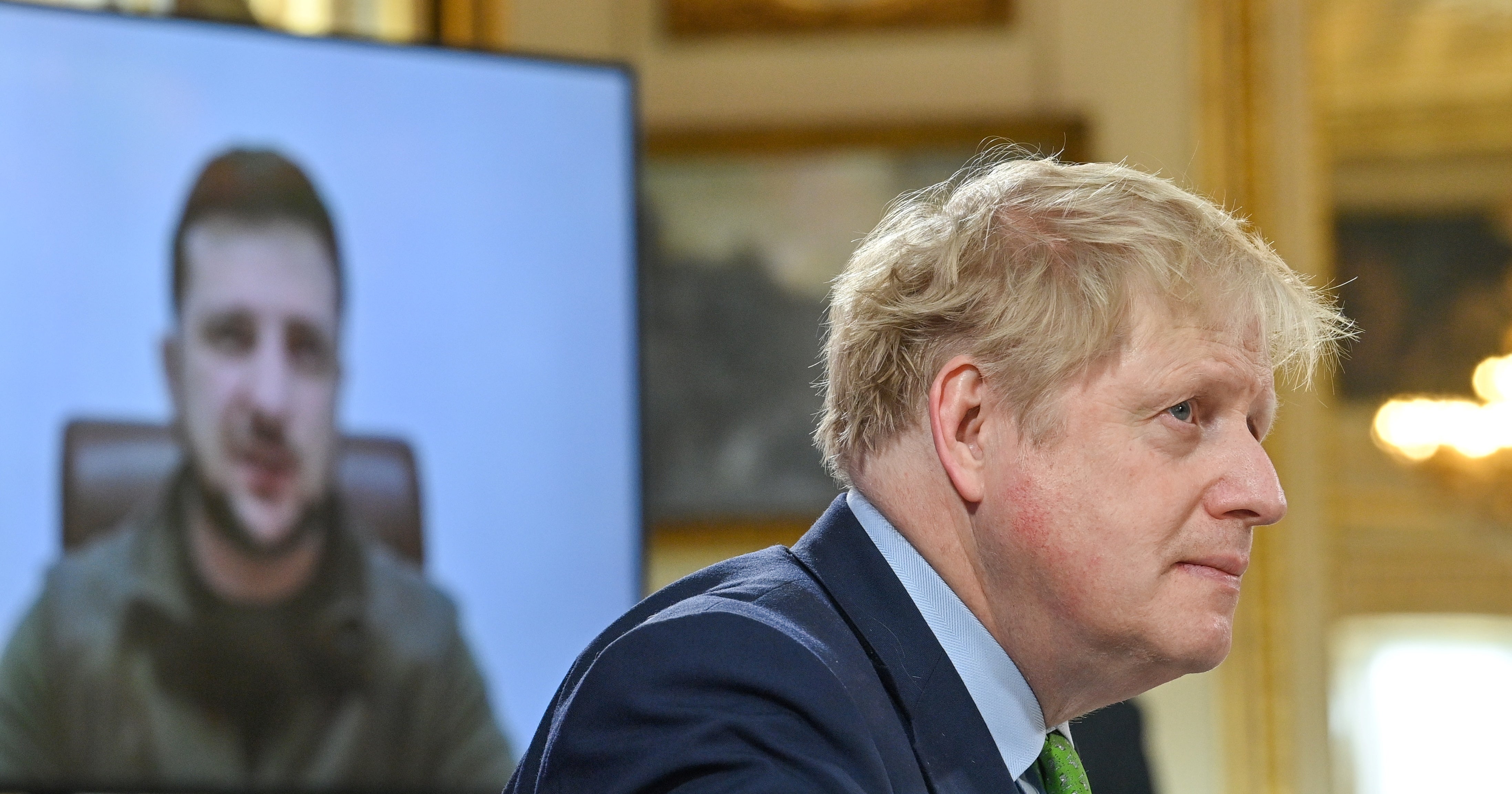 Prime Minister Boris Johnson listens as Ukrainian President Volodymyr Zelensky addresses by video link leaders attending a summit of the Joint Expeditionary Force in London (Justin Tallis/PA)