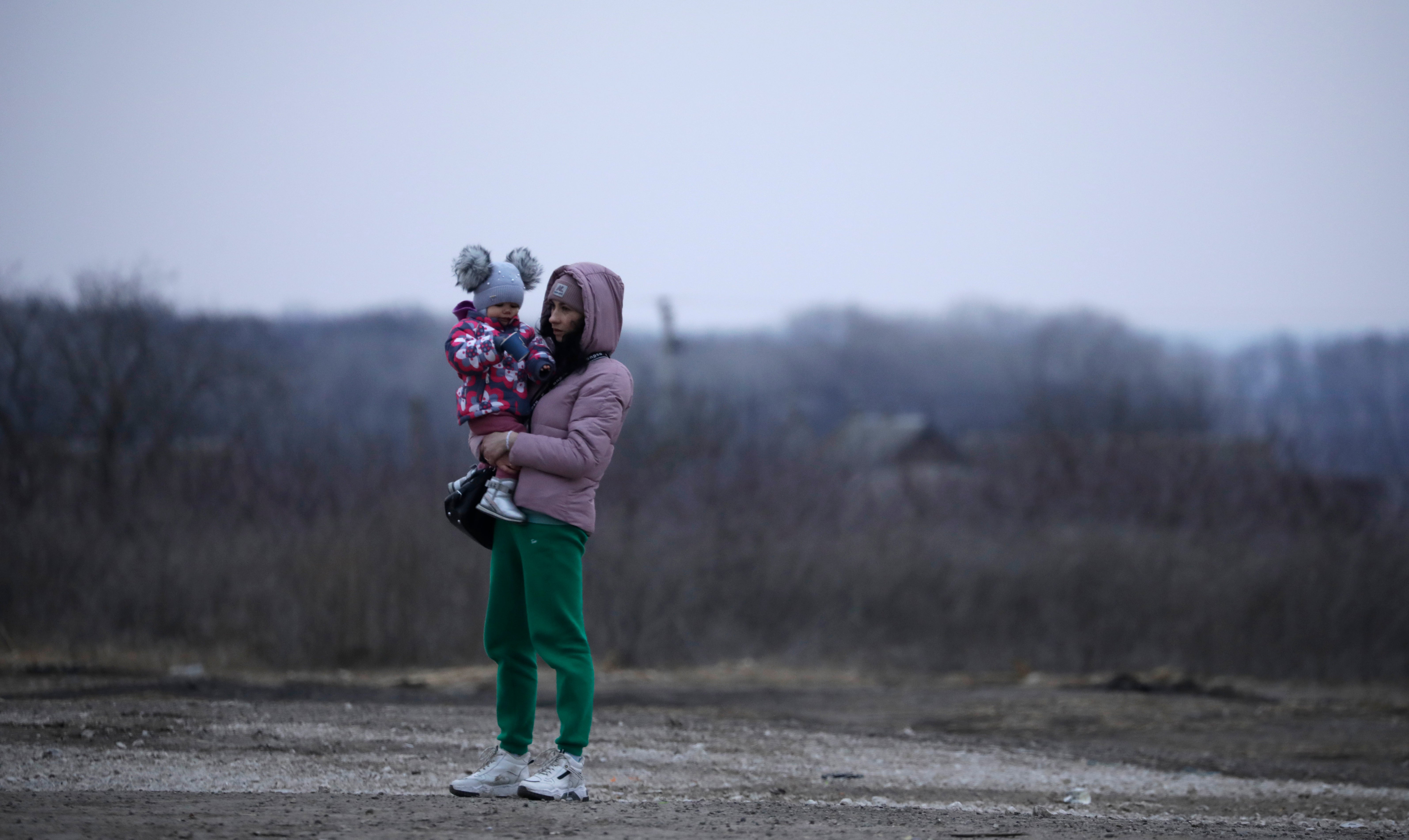 A Ukrainian woman who fled the conflict stands with her child at the refugee reception centre near Palanka, Moldova, 13 March 2022
