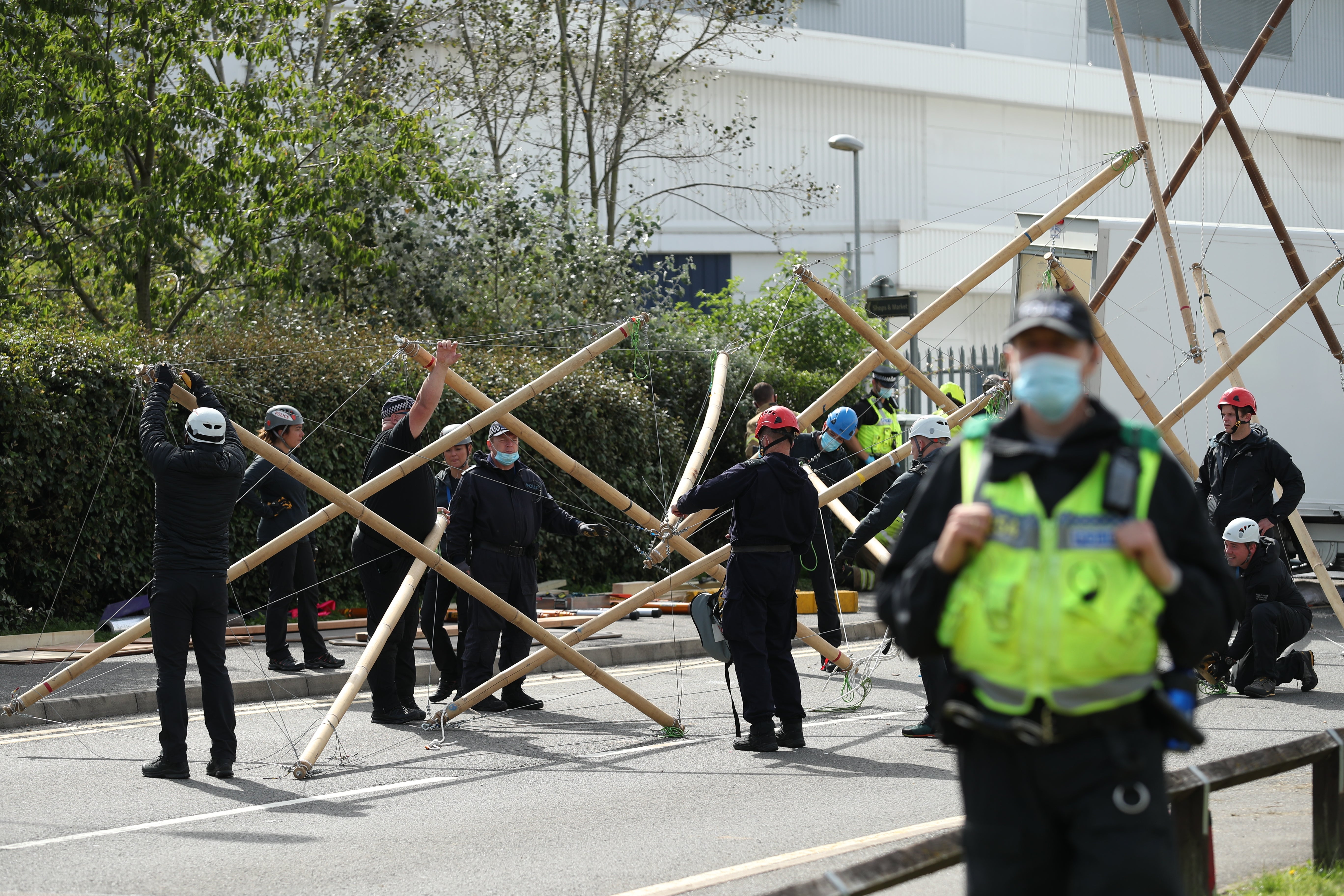 Emergency services dismantle the bamboo lock-ons used to block the road outside the Newsprinters printing works at Broxbourne, Hertfordshire (Yui Mok/PA)