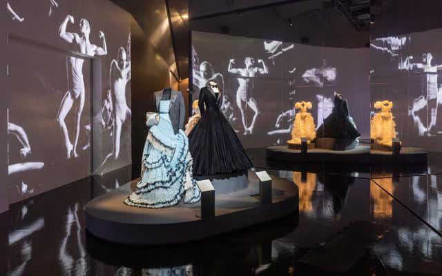 <p>Alessandro Michele for Gucci gown and tailored jacket worn by Harry Styles, Christian Siriano tuxedo gown worn by Billy Porter, and Ella Lynch wedding dress worn by Bimini Bon Boulash. Film by Quentin Jones with Cadence Films. Installation view, finale of Fashioning Masculinities: The Art of Menswear at V&A </p>