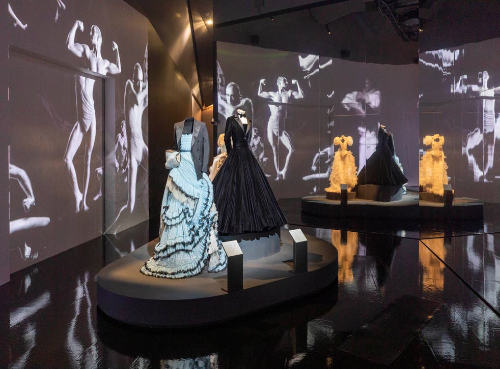 <p>Alessandro Michele for Gucci gown and tailored jacket worn by Harry Styles, Christian Siriano tuxedo gown worn by Billy Porter, and Ella Lynch wedding dress worn by Bimini Bon Boulash. Film by Quentin Jones with Cadence Films. Installation view, finale of Fashioning Masculinities: The Art of Menswear at V&A </p>