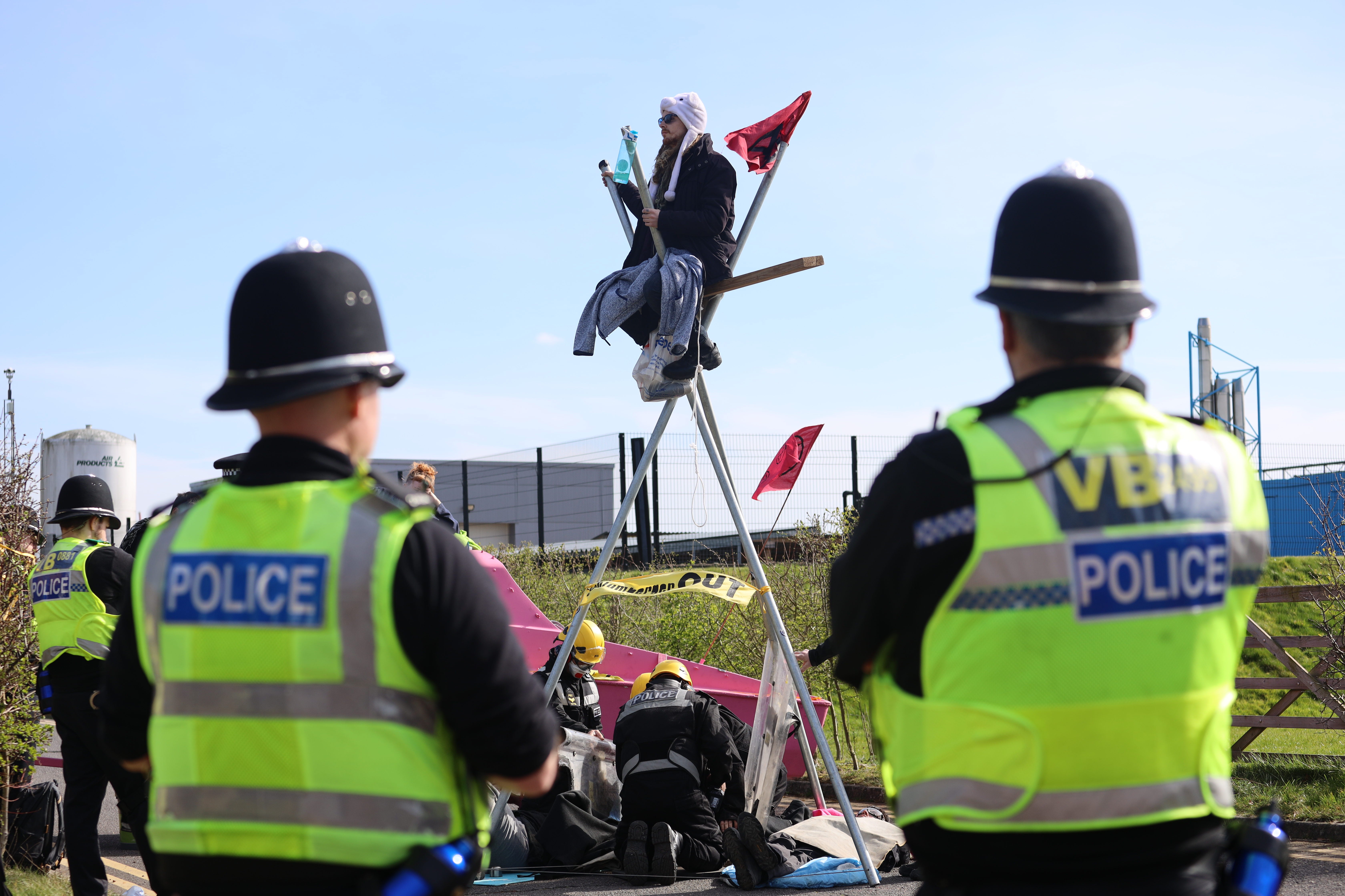 Police arrest a protester at Schlumberger’s research campus in Cambridge