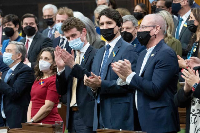 <p>Canadian Prime Minister Justin Trudeau (C) applauds with members of parliament following a virtual address by Ukrainian President Volodymyr Zelensky on March 15, 2022, in Ottawa</p>