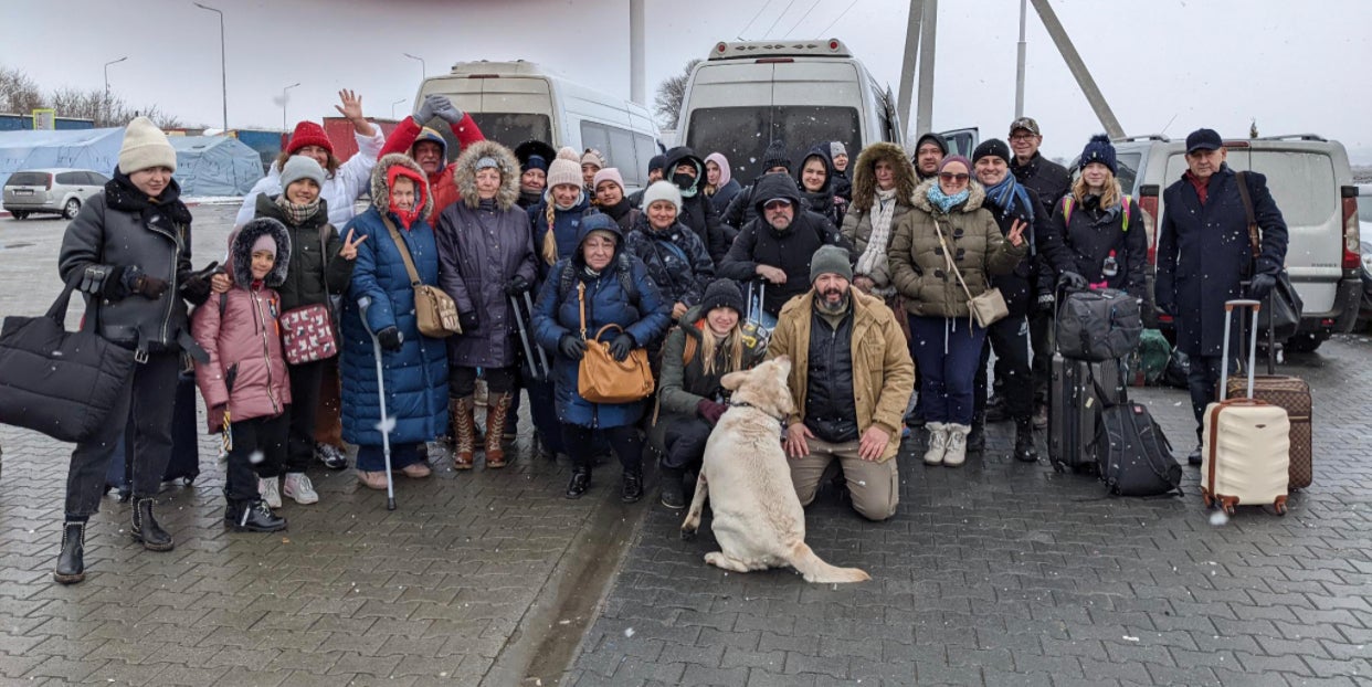 Project Dynamo’s Bryan Stern with a group of evacuees who have safely crossed the border out of Ukraine on one of his rescue missions