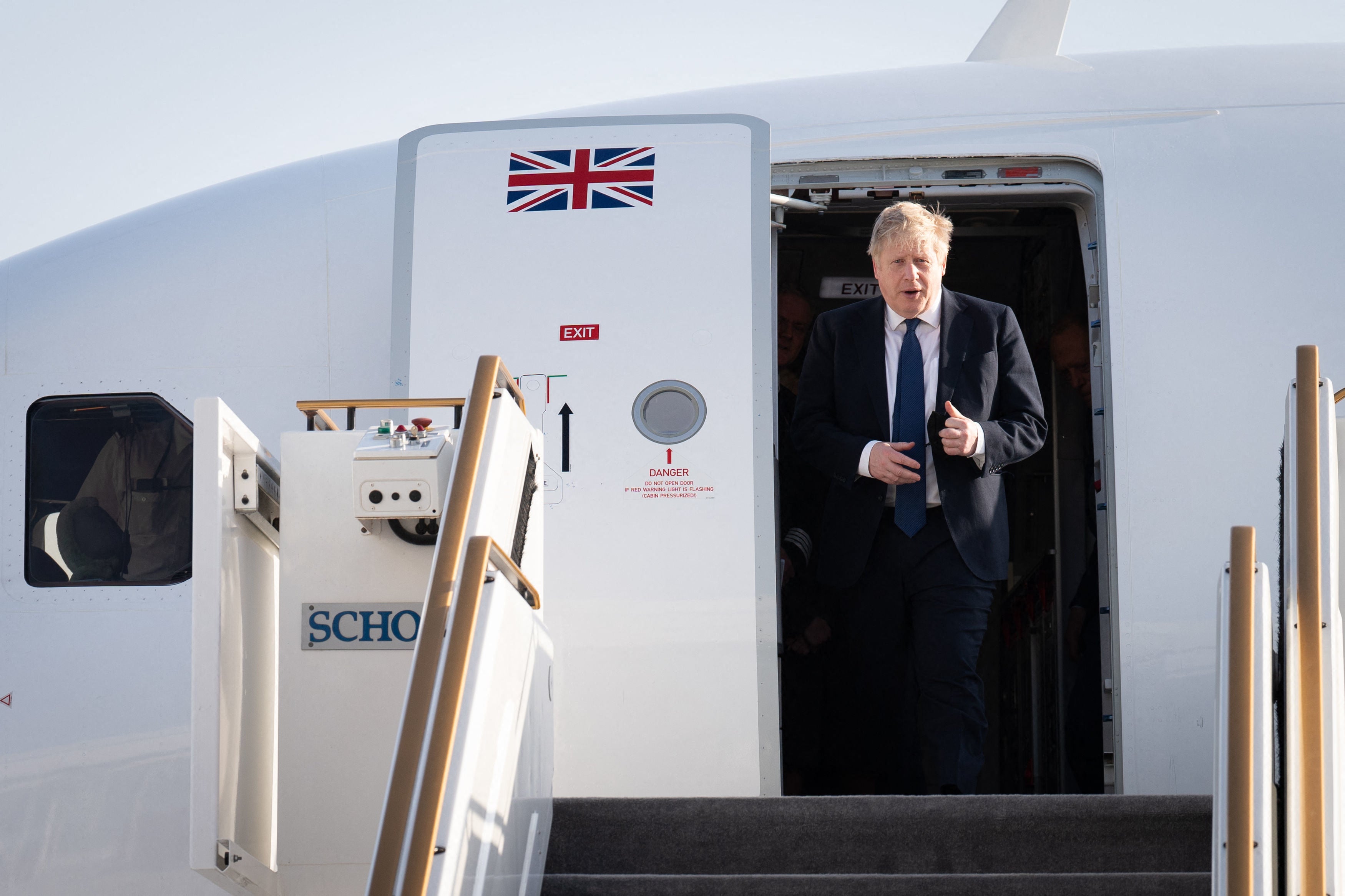 Boris Johnson steps off his plane as he arrives at Abu Dhabi - hours before his visit to Saudi Arabia