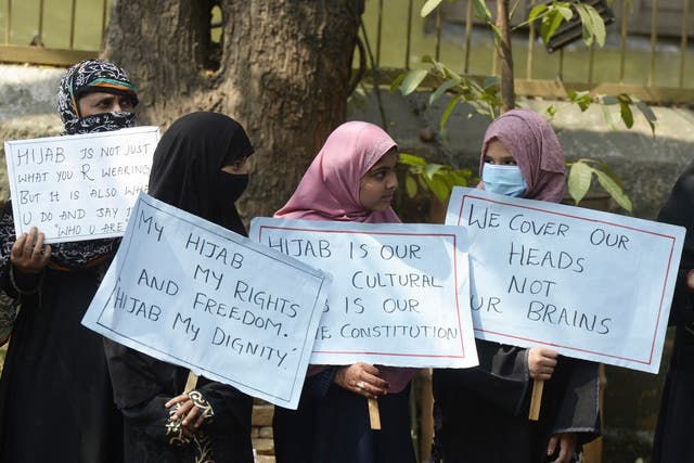 <p>File photo: Members from the Muslim Women Association hold placards during a silent protest in Hyderabad on 15 February</p>