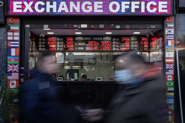 <p>People walk past a currency exchange office in Istanbul, Turkey, 11 November 2021</p>