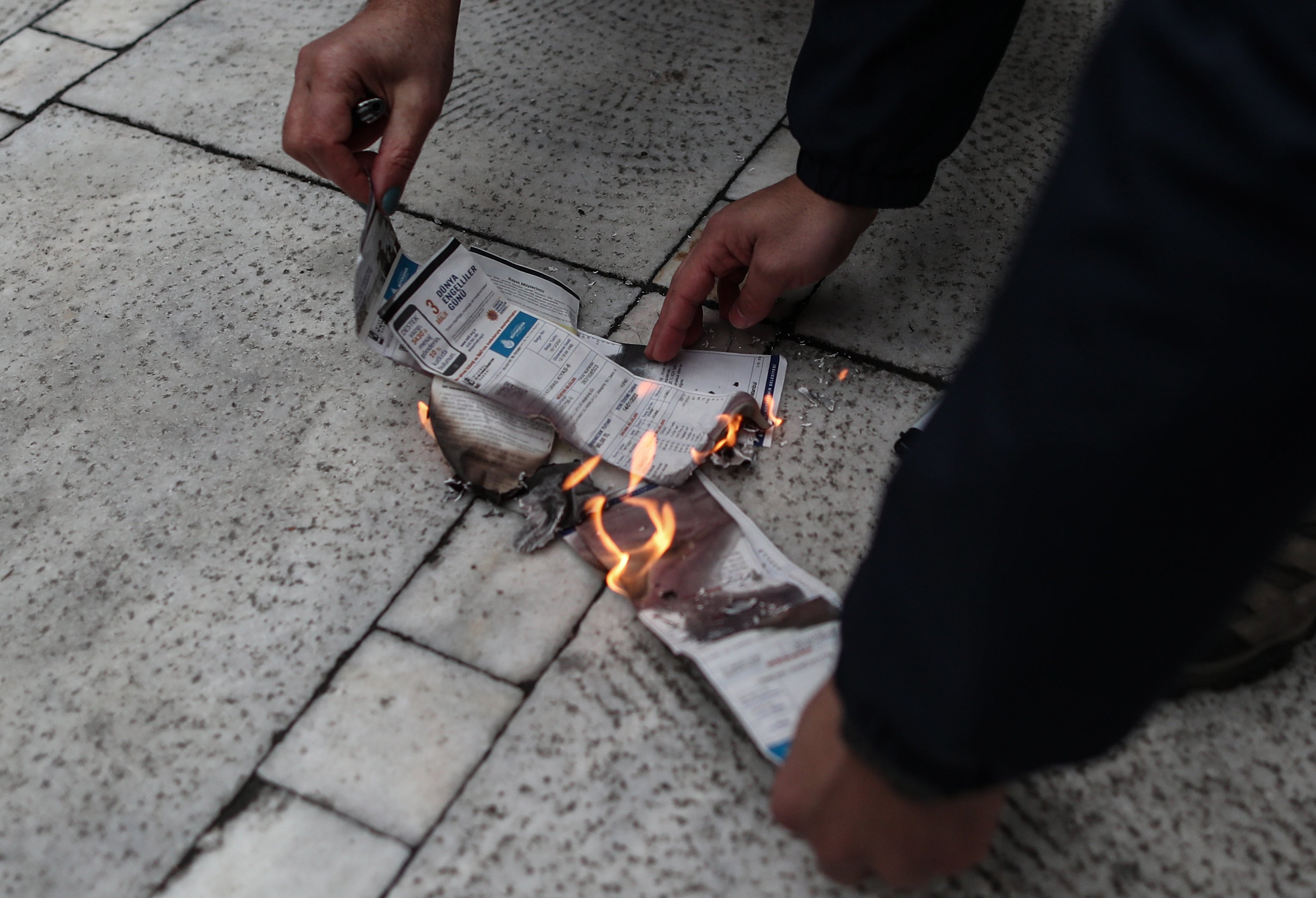 Protesters burn gas bills in Istanbul earlier this year