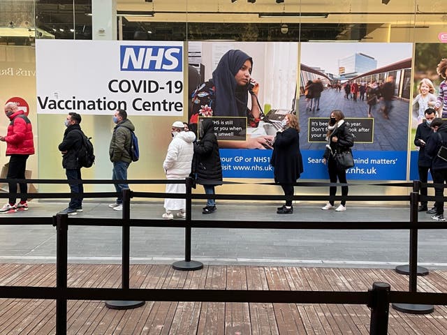 People queue at a Covid-19 vaccination centre at the Westfield shopping centre in Stratford, east London (Jonathan Brady/PA)