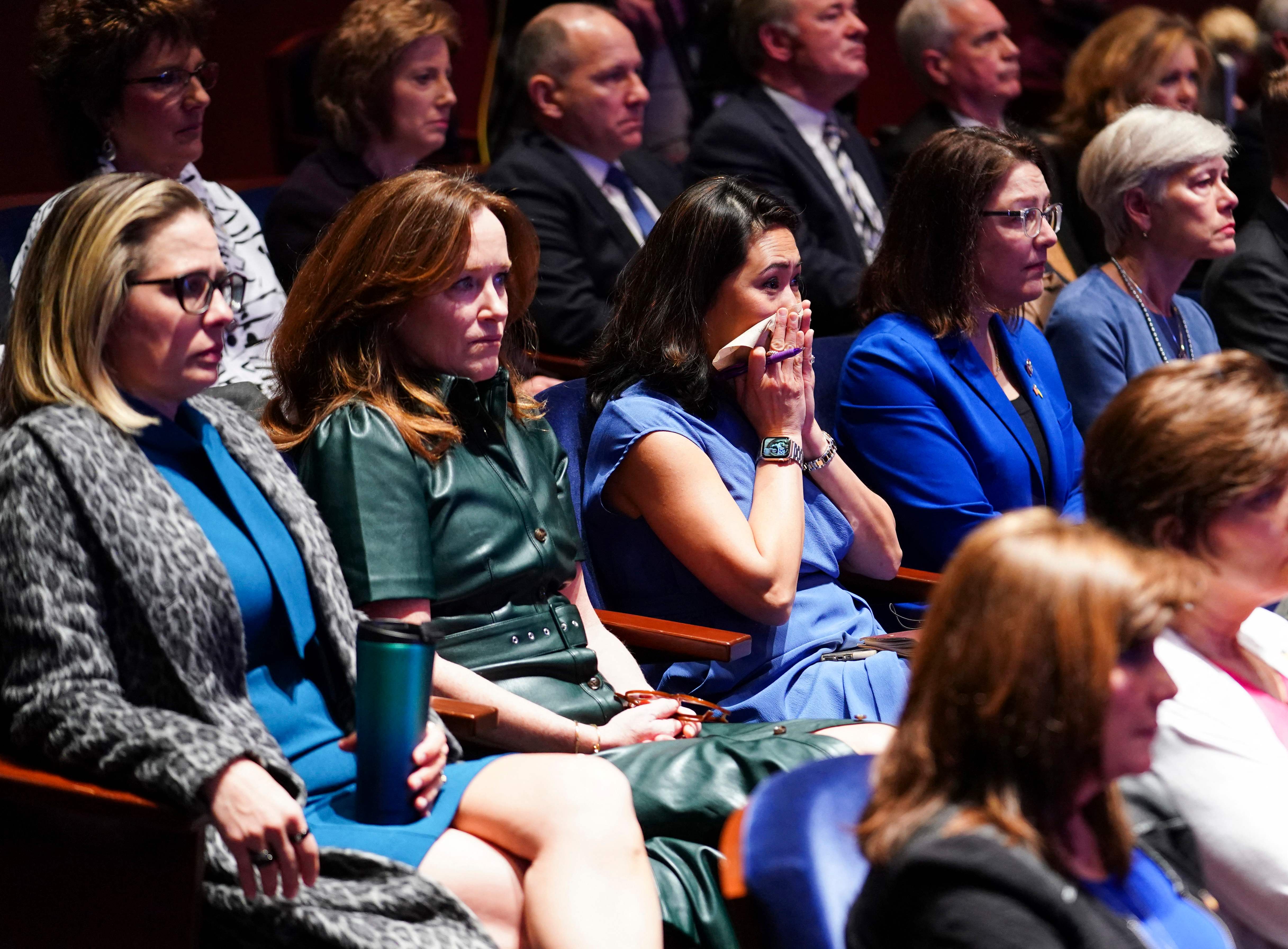 Members of the US Congress watch a video of the war in Ukraine during a virtual address by Ukrainian President Volodymyr Zelensky.