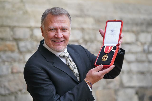 Ronald Howell with the knighthood conferred on his late partner, Sir Graham Vick, by the Prince of Wales during an investiture ceremony at Windsor Castle (Jonathan Brady/PA)