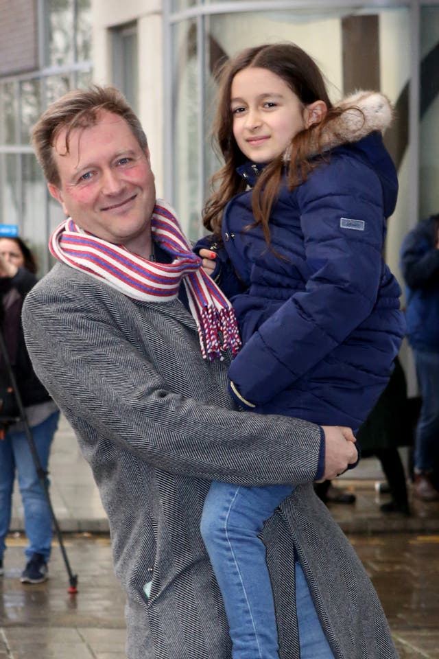 Richard Ratcliffe with his daughter Gabriella, outside his north London home ahead of his wife Nazanin Zaghari-Ratcliffe’s return (PA)