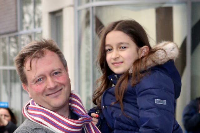 Richard Ratcliffe with his daughter Gabriella, outside his north London home ahead of his wife Nazanin Zaghari-Ratcliffe’s return (PA)
