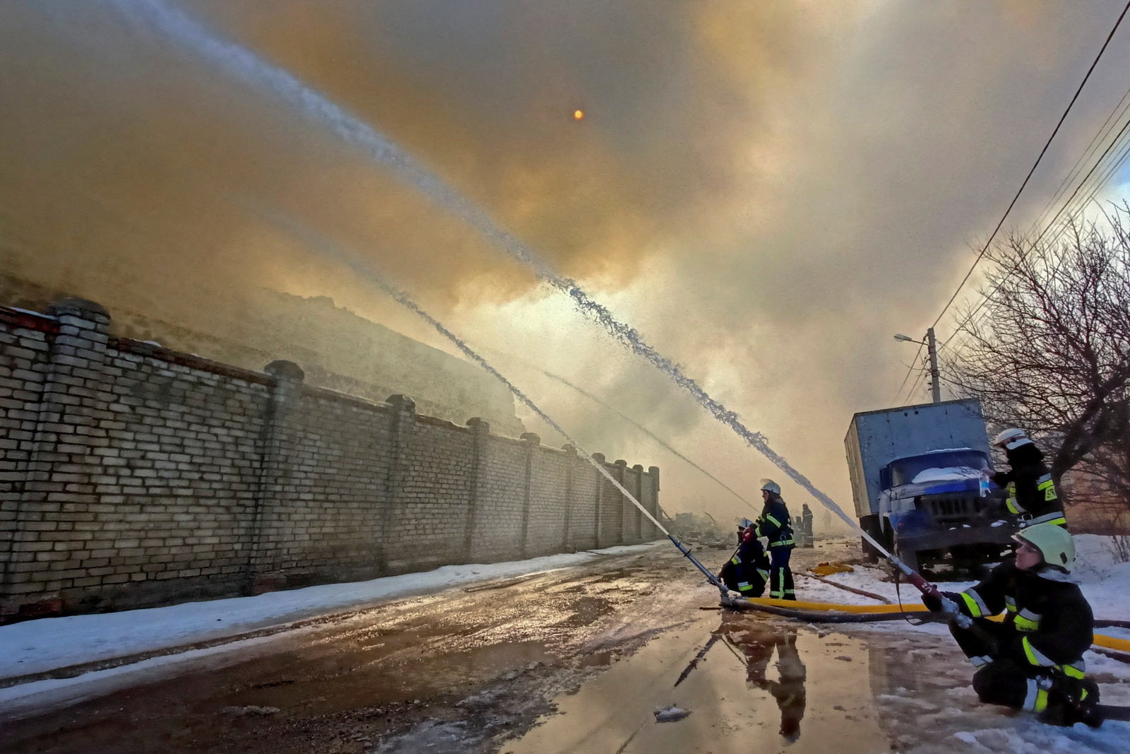 Rescuers tackle a warehouse blaze after shelling in Kharkiv