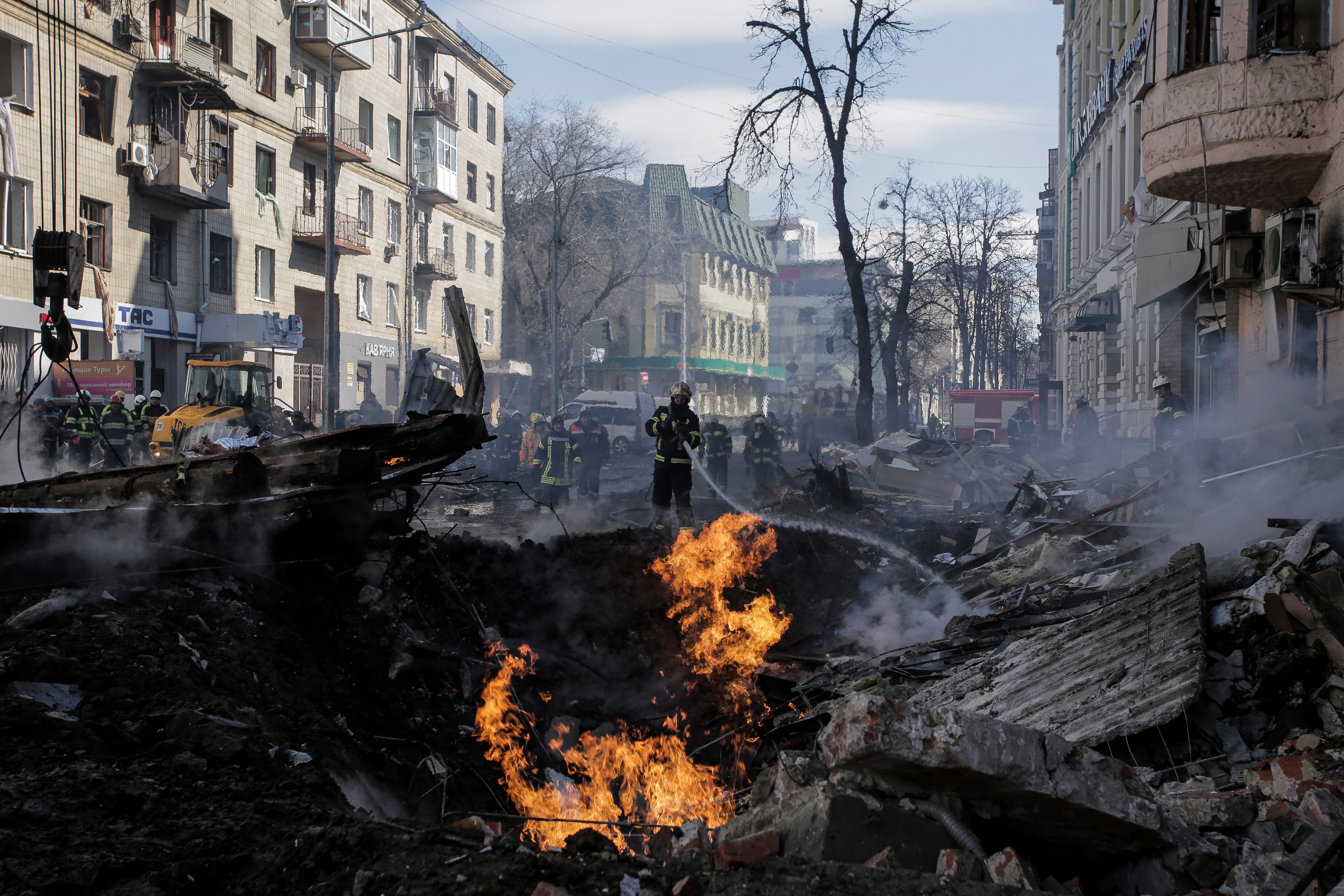 Firefighters extinguish flames outside an apartment house after a Russian rocket attack in Kharkiv, Ukraine’s second-largest city, Ukraine, Monday, March 14, 2022. (AP Photo/Pavel Dorogoy)