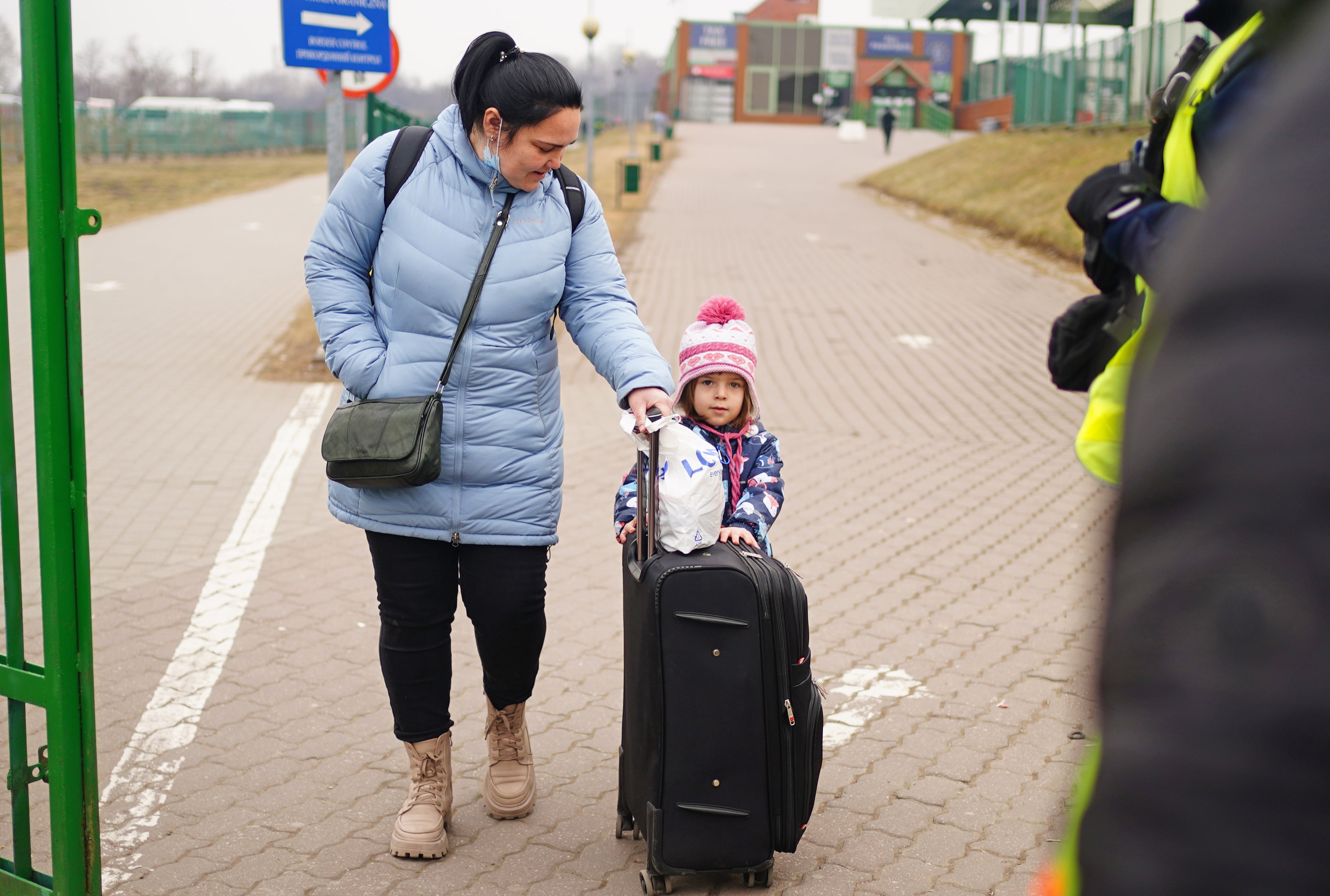 A family cross the border point from Ukraine into Medyka, Poland