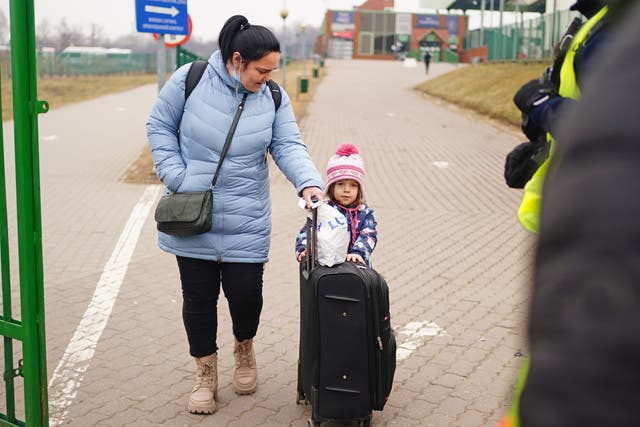 <p>A family cross the border point from Ukraine into Medyka, Poland</p>