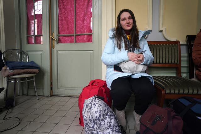 Yana Syniavina waits with her luggage at Przemysl train station in Poland after leaving Ukraine. (Victoria Jones/PA)